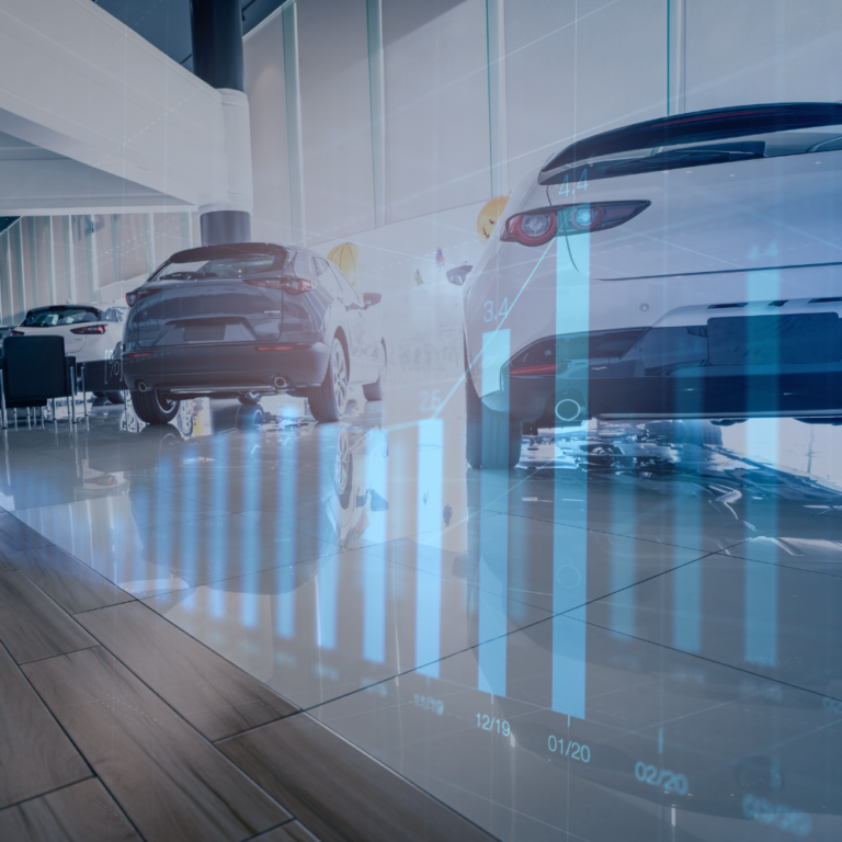 Moderne Autohalle mit zwei Fahrzeugen und grafischen Datenvisualisierungen auf dem Boden.